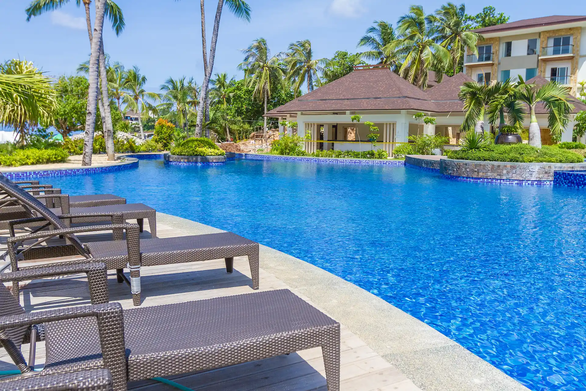 Daylight shot at the side of a large, inground resort pool. Increased business from the tourism sector is one of the trends likely to take hold in the pool industry in 2023.